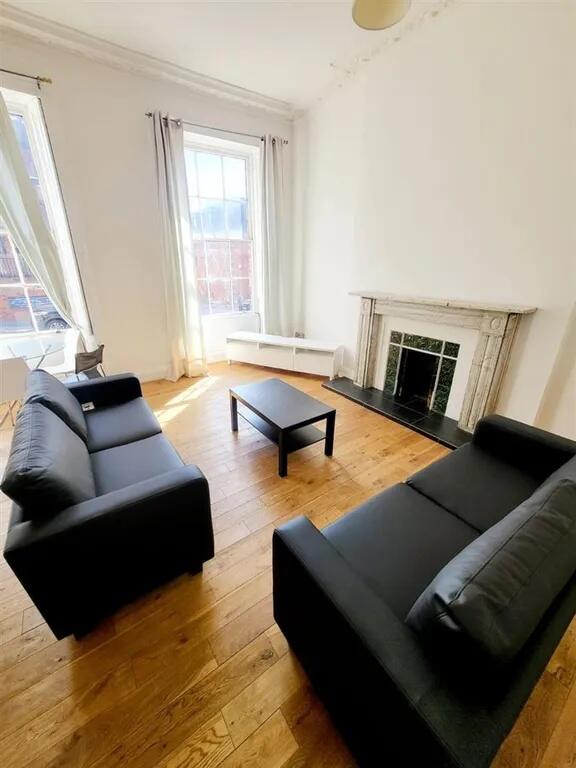 Bright and inviting living room with two comfor...