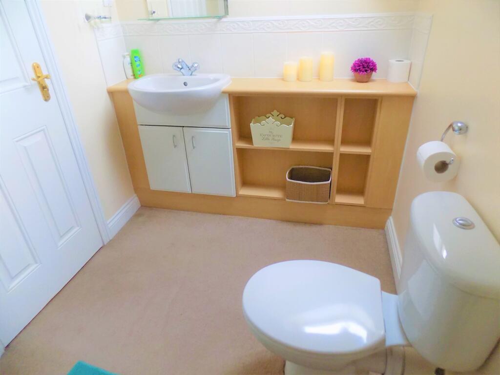 Bright and clean bathroom featuring a white toi...