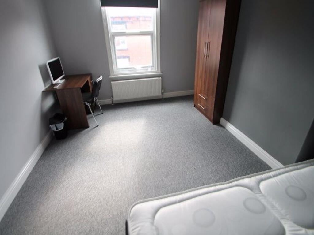 A neat and simple single bedroom featuring a cl...