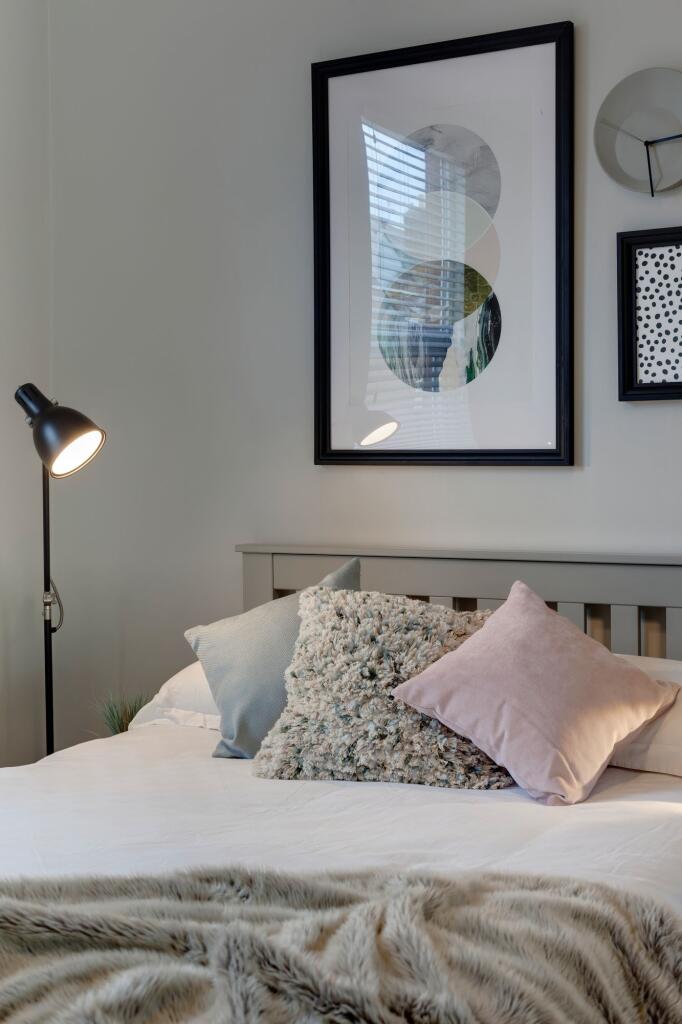A bright, well-maintained master bedroom featur...