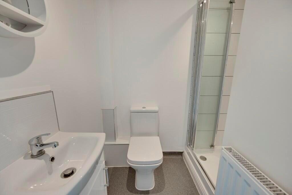 A clean and modern bathroom featuring a white s...