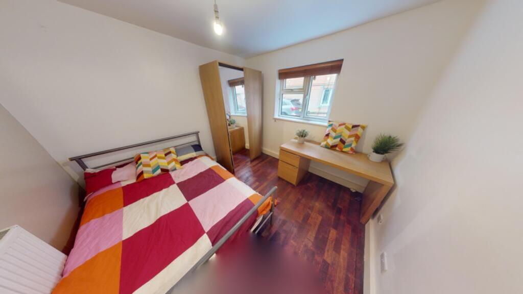 A bright and inviting double bedroom featuring ...