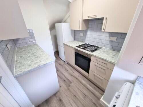Bright and tidy kitchen with modern cabinetry, ...