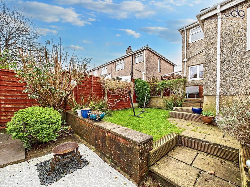 Tiered Garden with a mixture of flags, decking and lawn.