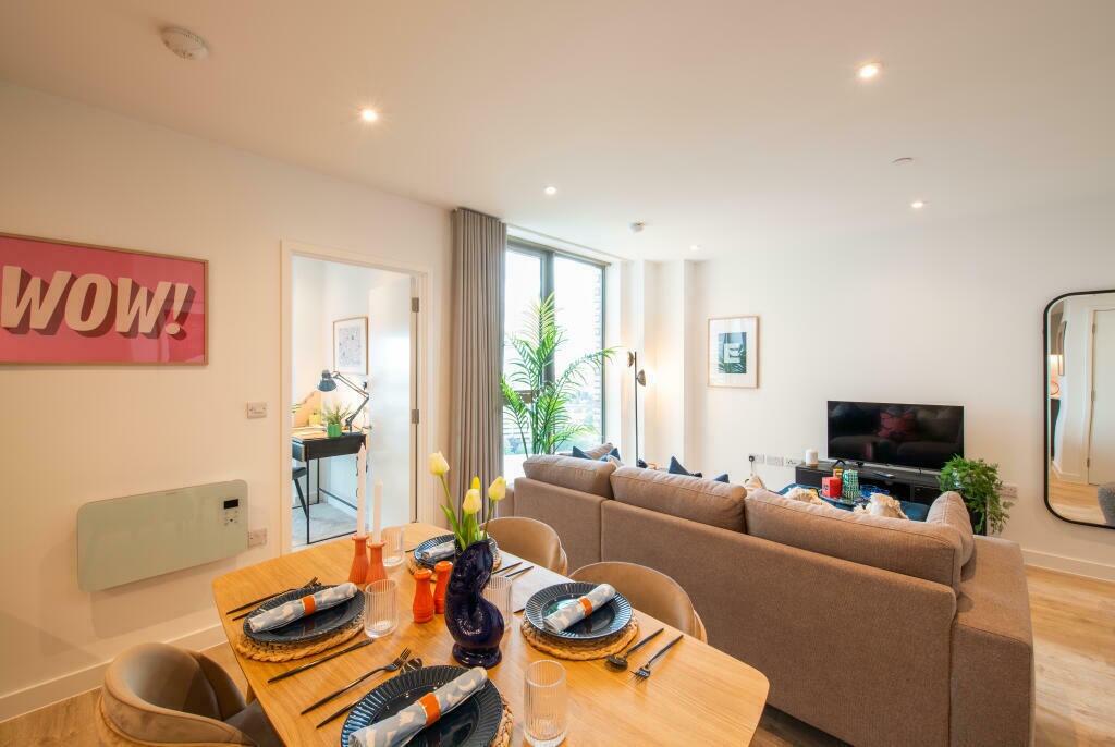 Bright and stylish living room featuring a spac...