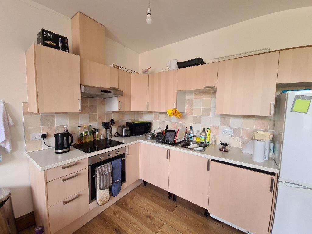 A modern, well-equipped kitchen featuring light...