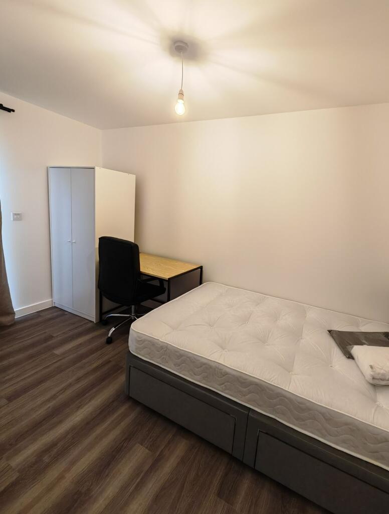 A neat and simple single bedroom featuring a co...