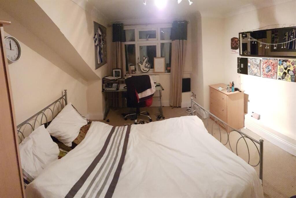 A cozy and inviting master bedroom featuring a ...