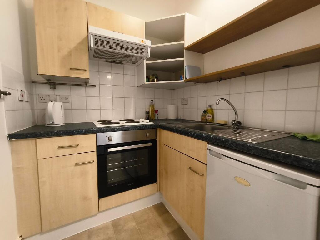 Compact and functional kitchen with light wood ...