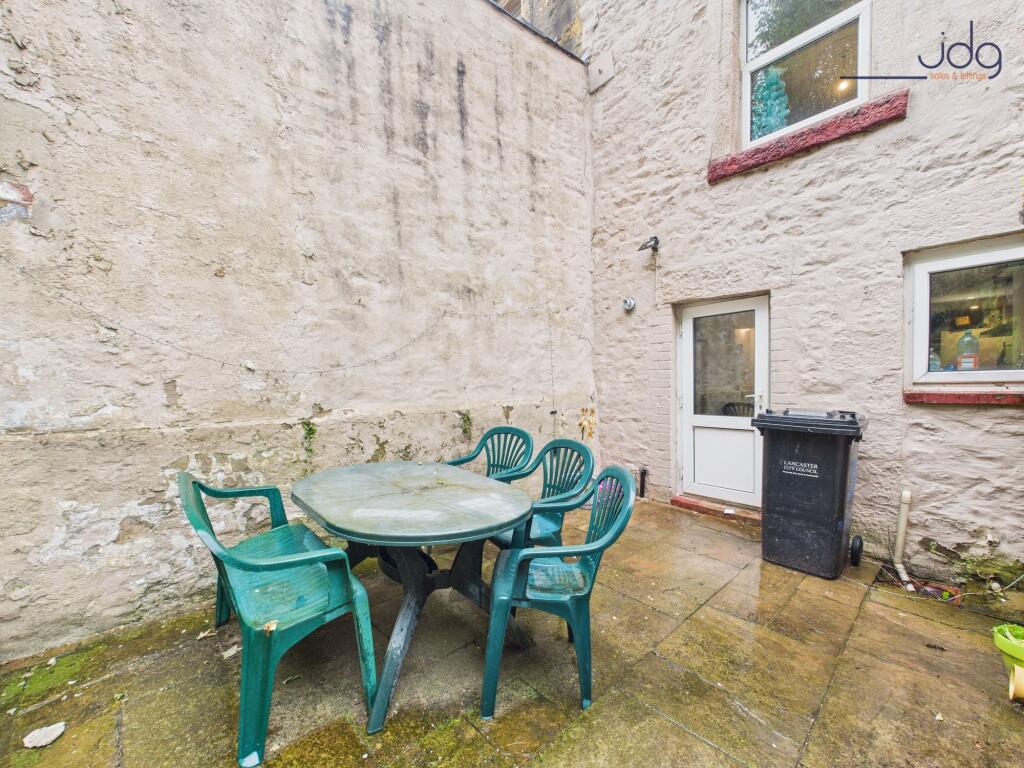 Tiered Yard with room for seating and treeline backdrop