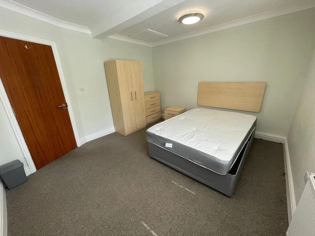 Bright and tidy double bedroom featuring a comf...