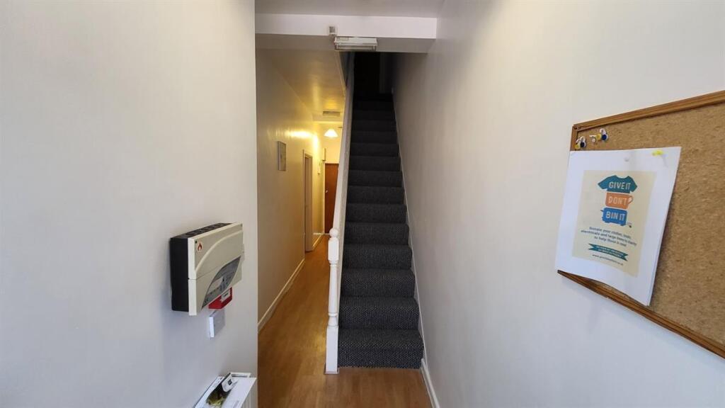 A clean and well-maintained hallway featuring w...