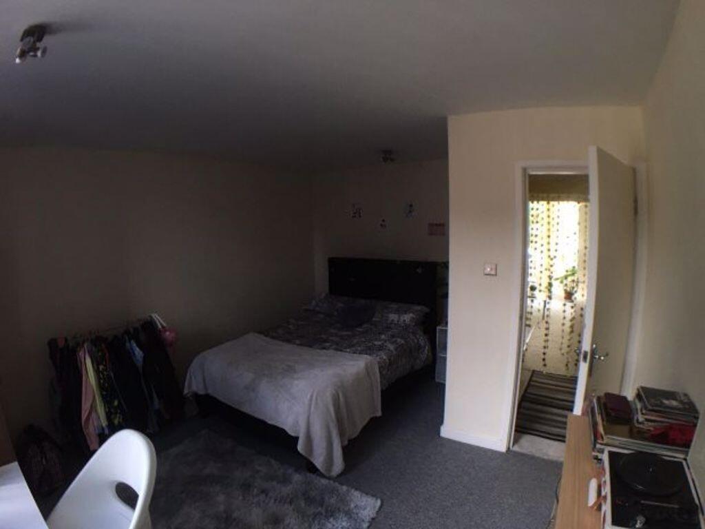 Cozy bedroom with a double bed, neutral decor a...