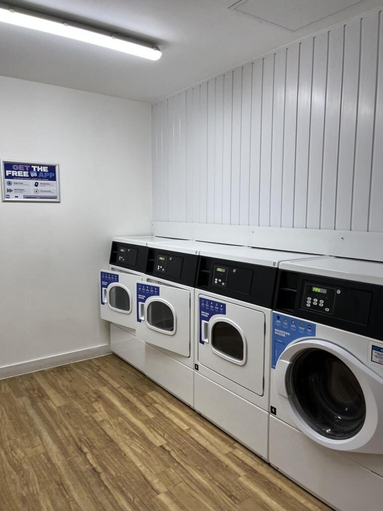 Bright and clean laundry room featuring multipl...