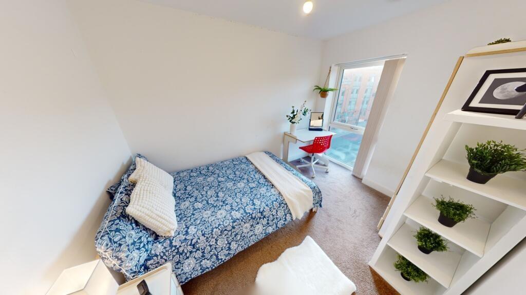 Bright and tidy bedroom featuring a comfortable...