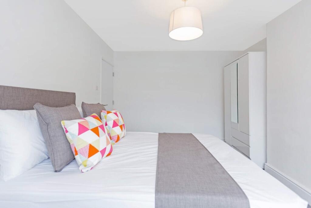 A spacious and bright double bedroom, featuring...
