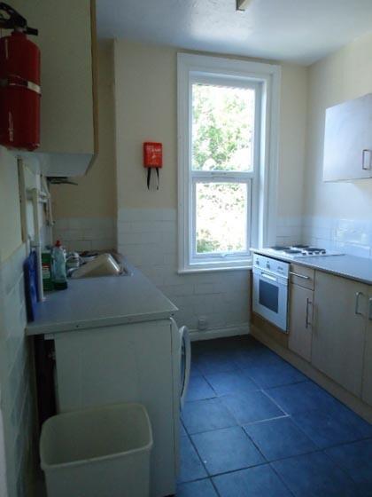 A compact, well-lit kitchen with a window provi...