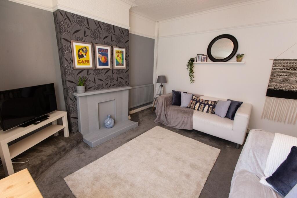 A clean and inviting living room with modern de...