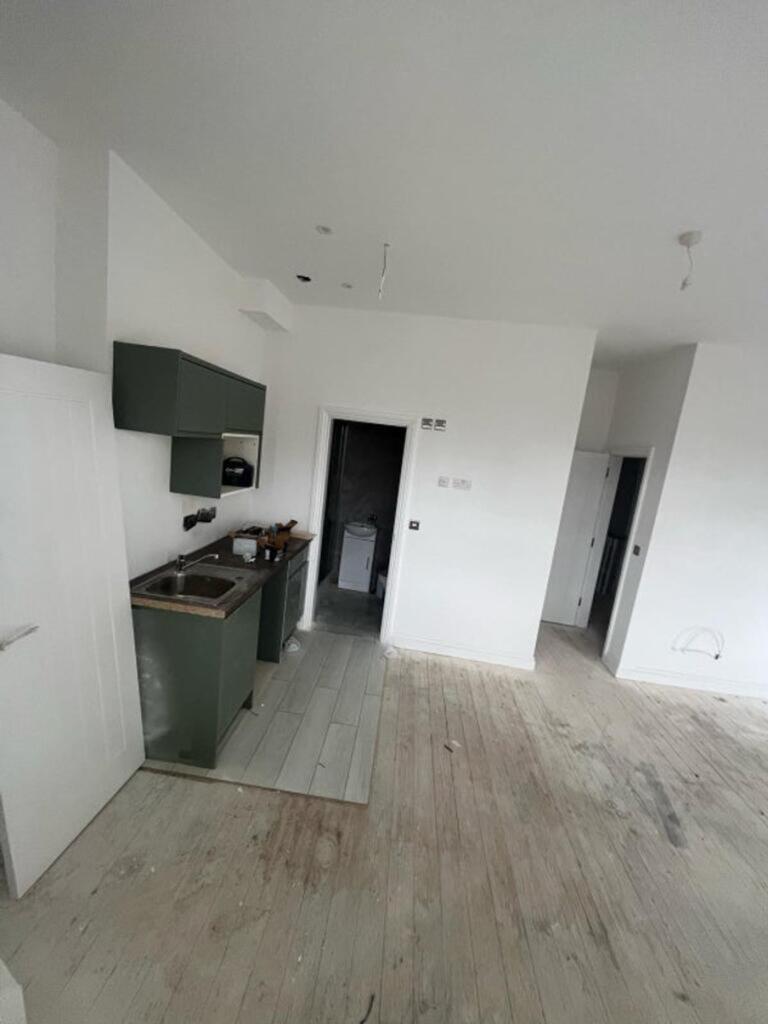 This modern kitchen boasts sleek cabinetry and ...