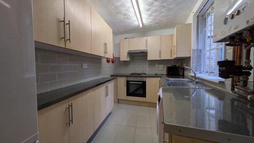 A bright and tidy kitchen featuring modern cabi...
