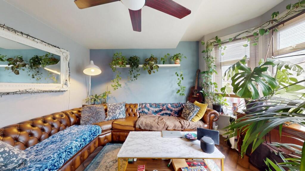 A bright and inviting living room featuring a c...