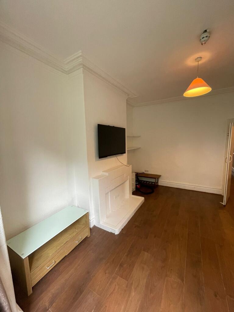 A cozy living room featuring a fireplace and am...