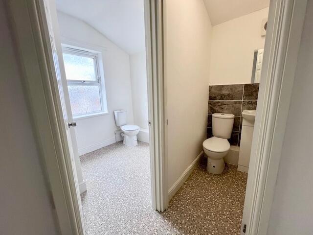 Bright and clean single toilet area with natura...