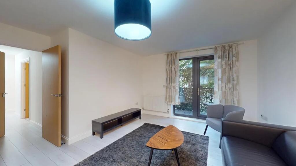 A contemporary living room featuring a dark gre...