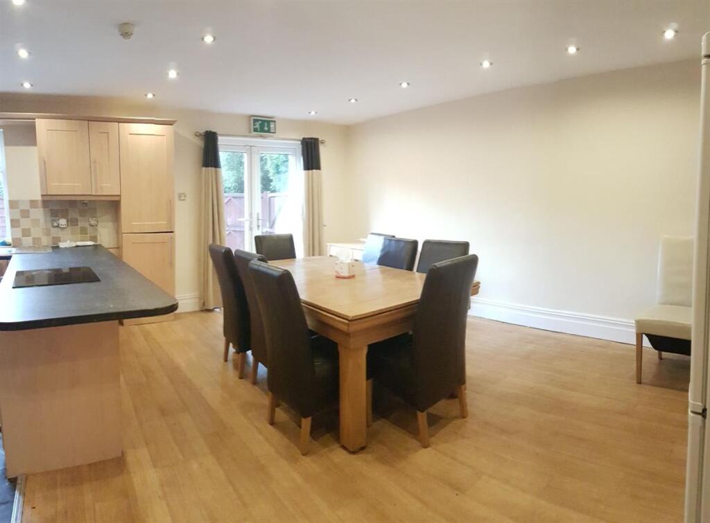 Bright open-plan kitchen and dining area with w...