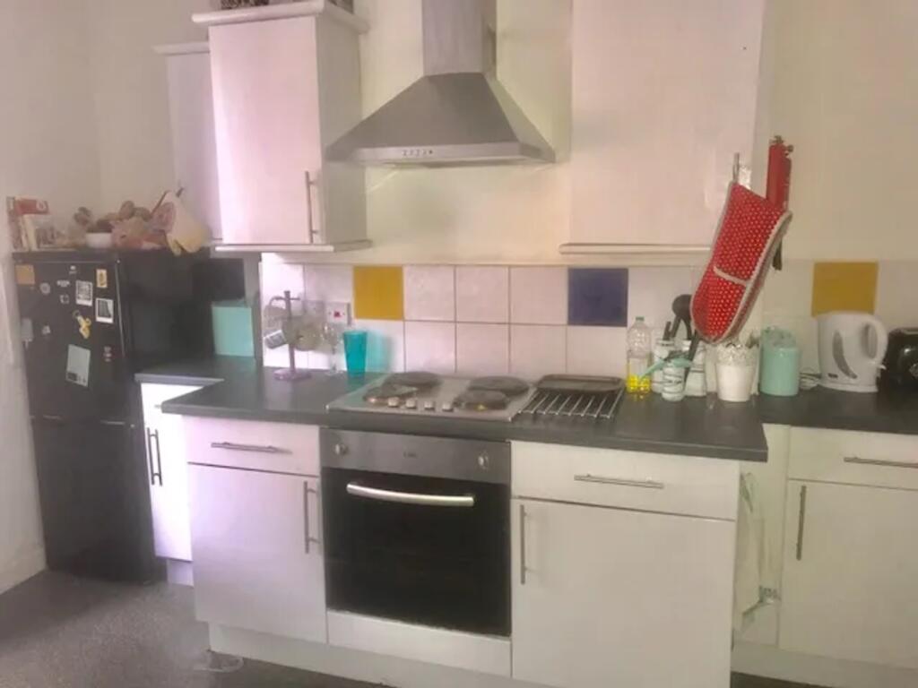 A functional and tidy kitchenette with modern a...