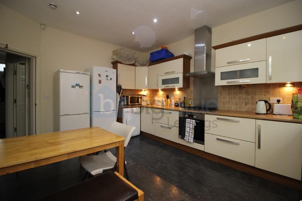 Bright and modern kitchen featuring cream cabin...