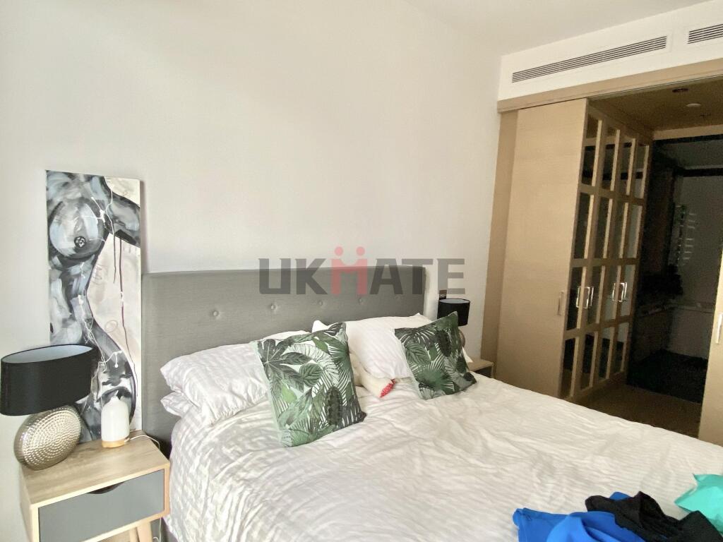 A spacious and inviting master bedroom featurin...