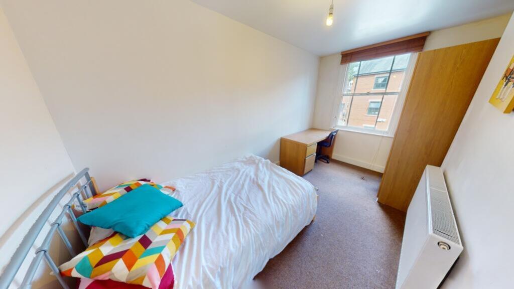 A bright and inviting double bedroom featuring ...