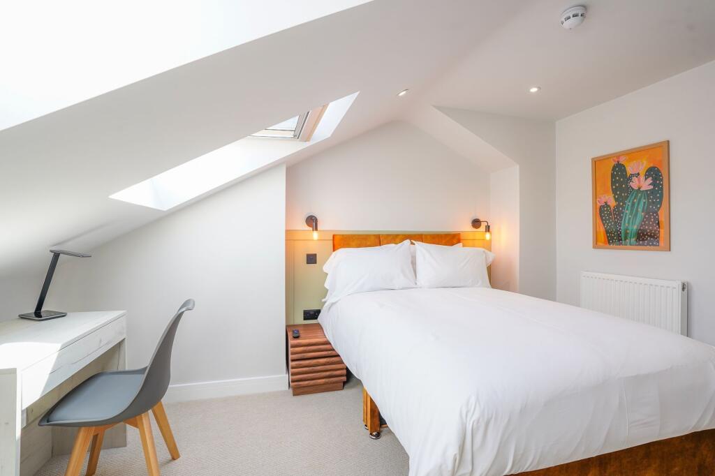 Bright and cozy double bedroom featuring a comf...