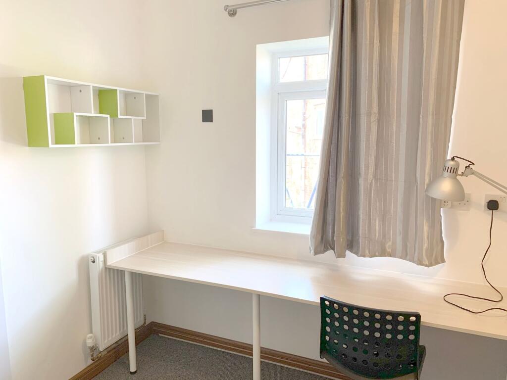 A bright and tidy communal workspace featuring ...