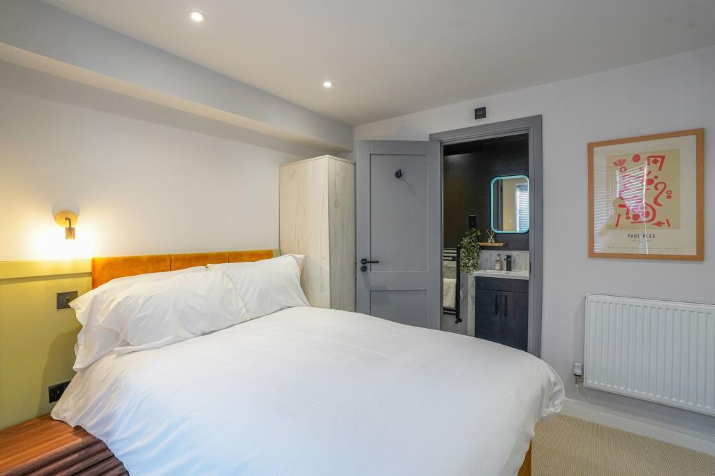 A modern and cozy bedroom featuring a large, ne...