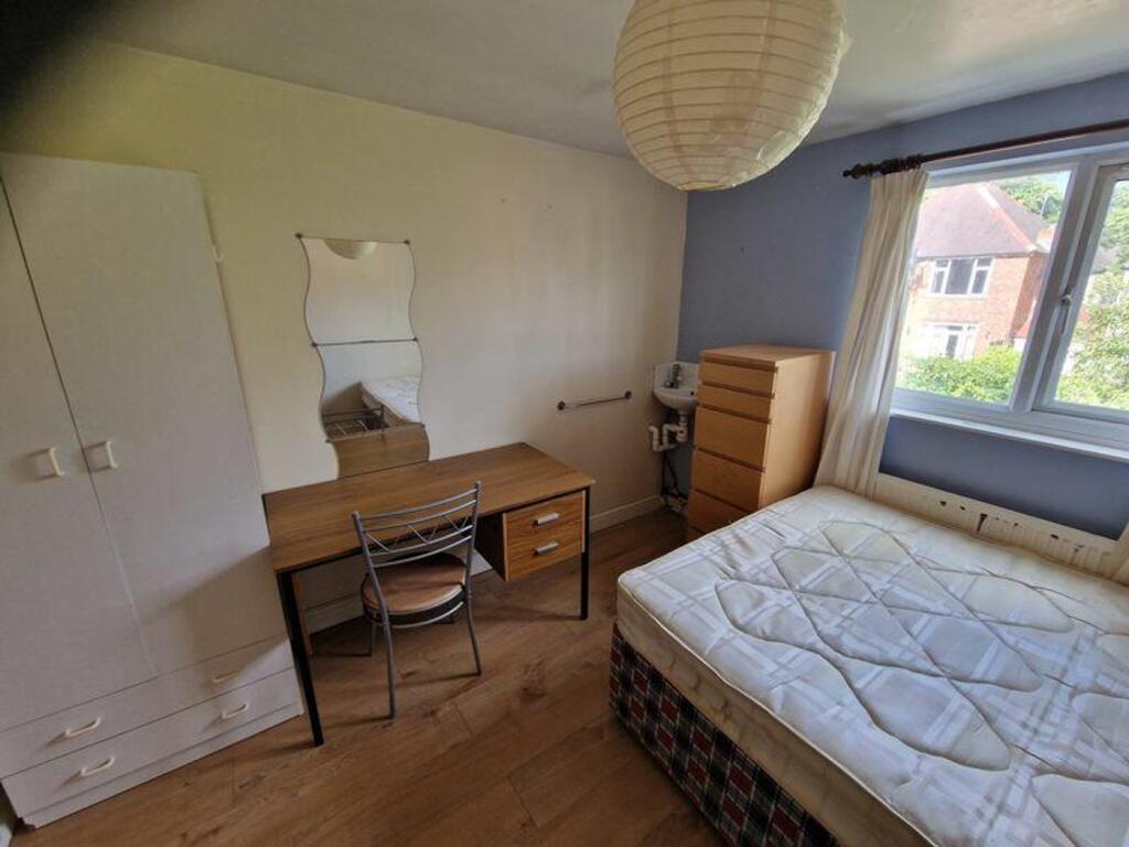 A spacious and inviting double bedroom featurin...
