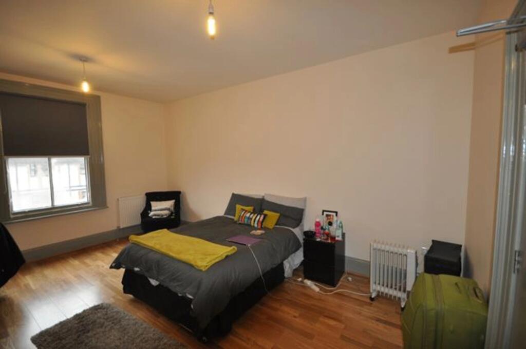 A spacious and inviting double bedroom with mod...
