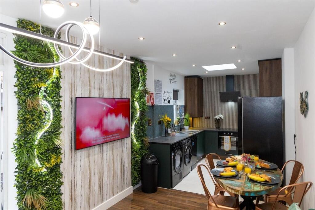 A modern, stylish kitchen featuring sleek black...
