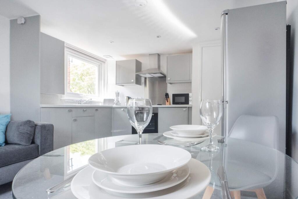 This modern kitchen combines sleek design with ...