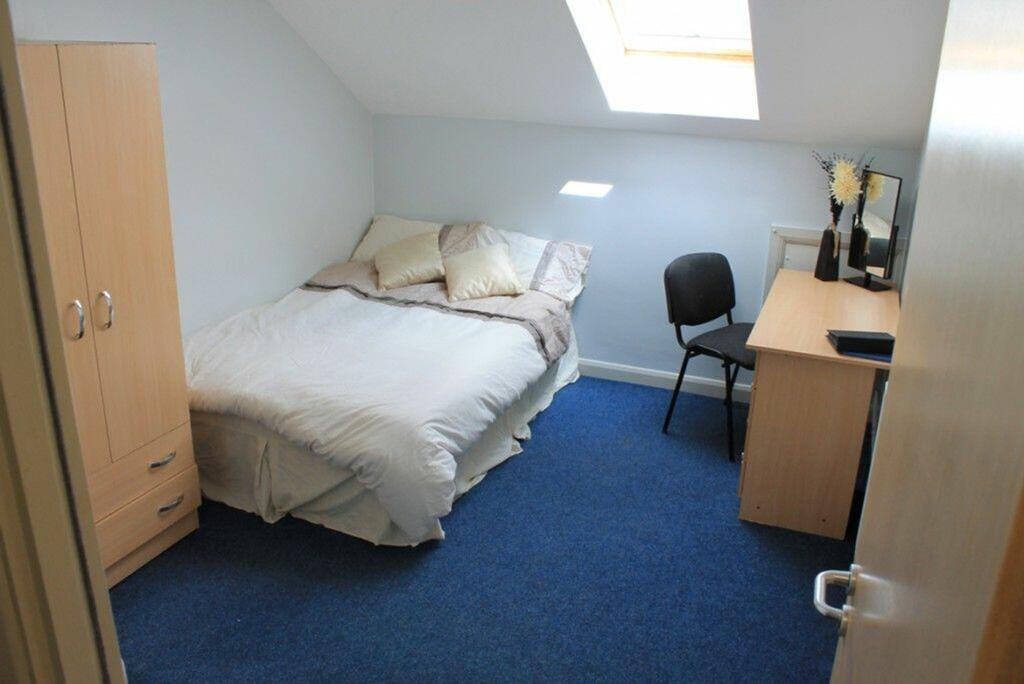 Cozy double bedroom featuring a comfortable bed...