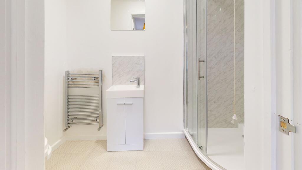 A clean and modern bathroom featuring a spaciou...