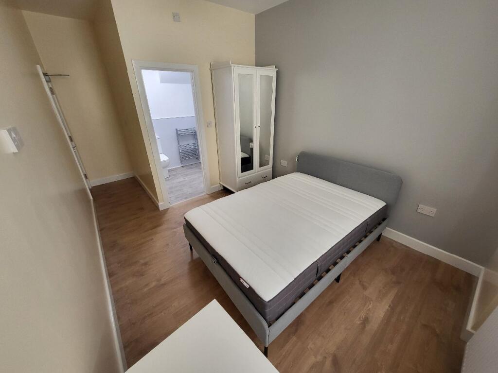 This inviting double bedroom features a cozy la...