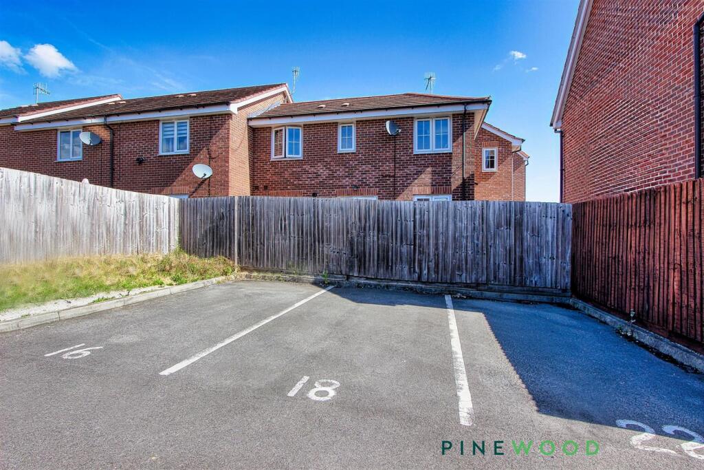 PARKING SPACE AND REAR OF HOUSE