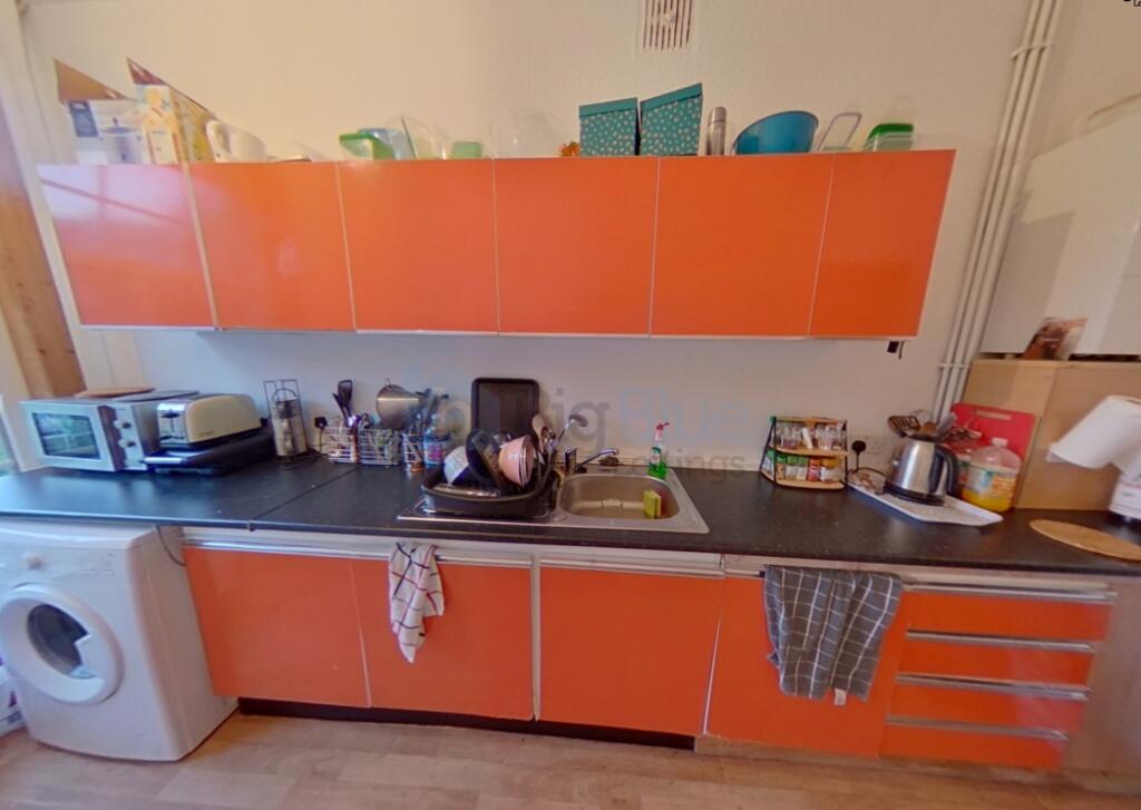Bright, functional kitchen space with vibrant o...