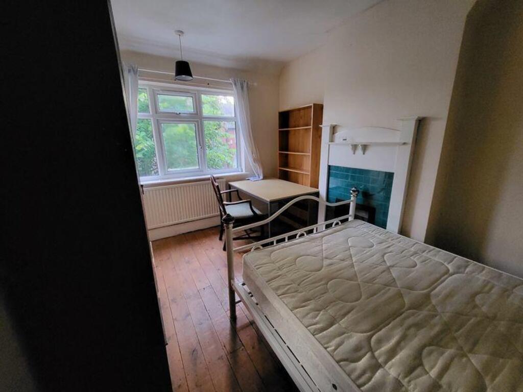 A bright and inviting double bedroom featuring ...