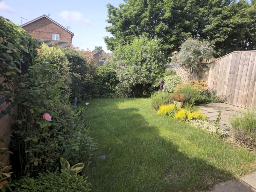 A beautifully maintained garden featuring lush ...