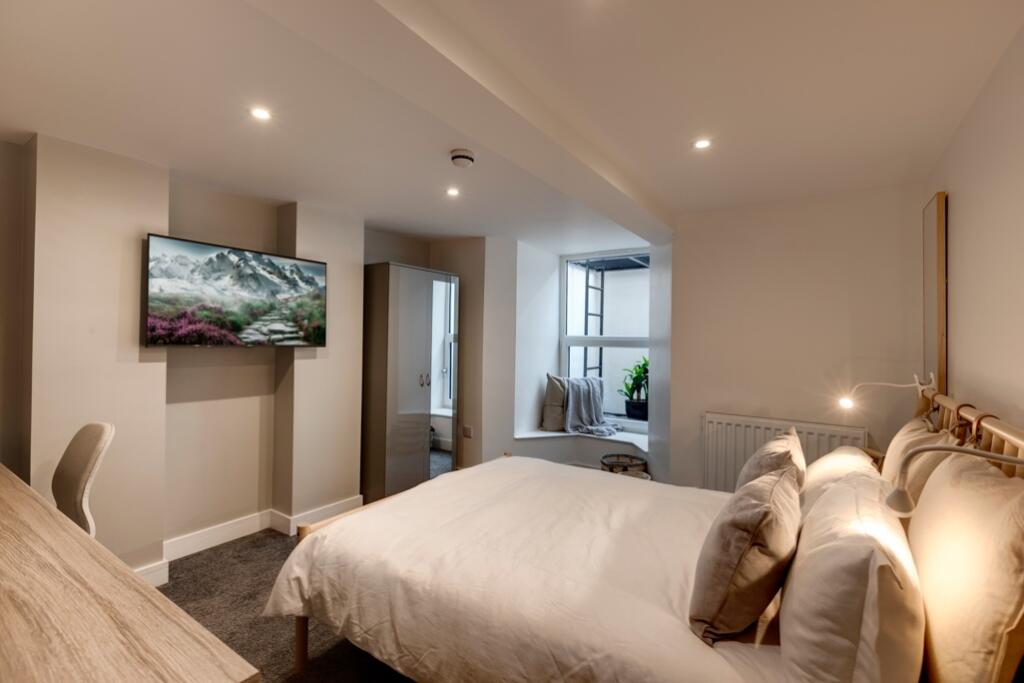 A cozy and neatly maintained bedroom featuring ...