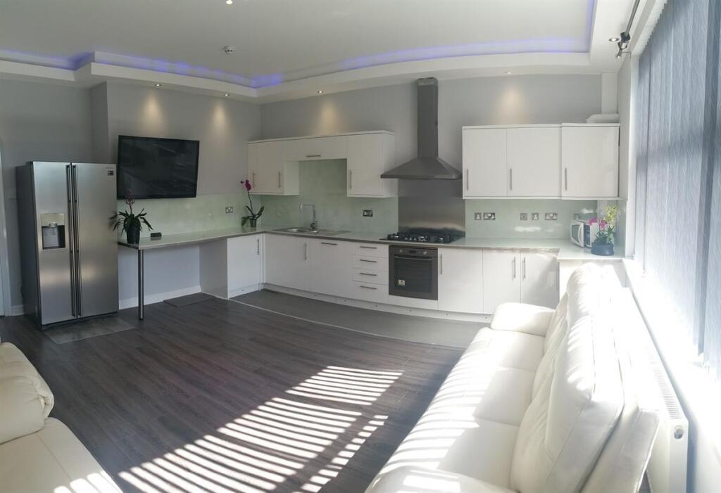 Bright, modern open-plan living area with a sle...