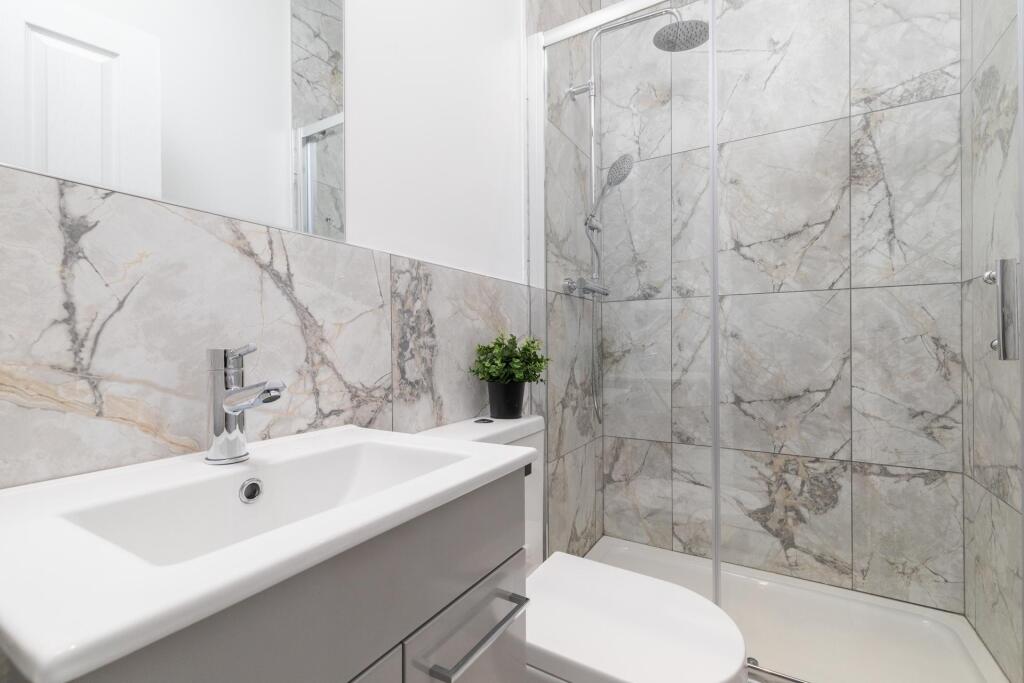A modern, clean bathroom featuring a spacious s...
